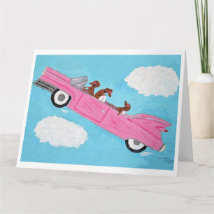 Tarjeta Dachshunds en convertible rosa en el cielo