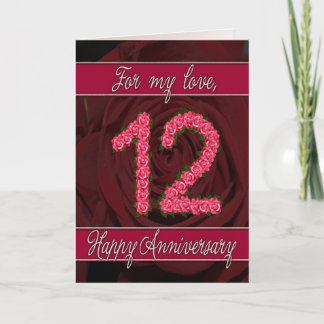 tarjeta de aniversario número 12 con rosas y hojas