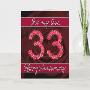 tarjeta de aniversario número 33 con rosas y hojas