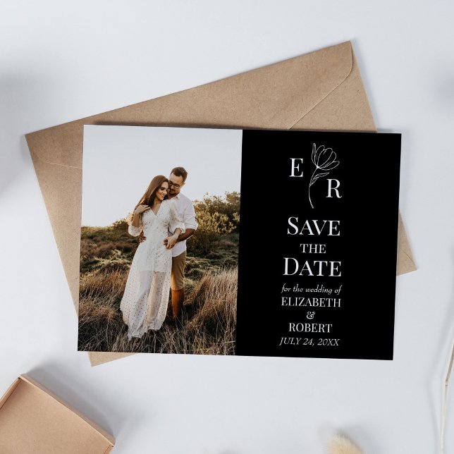 Tarjeta de anuncio de fecha de boda con monograma  (Black Floral Monogram Custom Photo Save the Date Invitation on white table with dry wildflowers.)