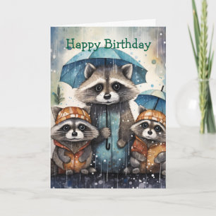 Tarjeta de cumpleaños de mapaches lindos en la llu