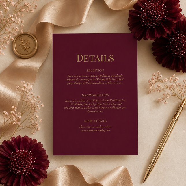 Tarjeta de Detalles de Boda con Monograma de Oro B (Burgundy Gold Monogram Wedding Details Card on ana elegant table with wedding decor & flowers)