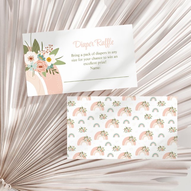 Tarjeta de envoltorio de pañal de arcoiris con flo (Pink Floral Rainbow Diaper Raffle Enclosure Card on a white dry palm leaf.)