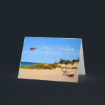 Tarjeta de felicitación de Beach Santa<br><div class="desc">Un caprichoso Navidad saludando a Santa y a su hijo en la playa con un avión que cuelga en el cielo y que volaba un mensaje de Feliz Navidad.</div>