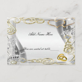 Tarjeta de lugar de mesa con anillos de boda y cor