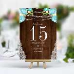 Tarjeta De Mesa Aqua Mint Rustic Wood String ilumina a Boda floral<br><div class="desc">Ilumine su boda rústico con estos encantadores números de mesa. Con delicadas flores acuáticas en suaves tonalidades de agua y menta, acentuadas por las brillantes luces de cuerda sobre un fondo rústico de madera, estas tarjetas crean un ambiente cálido y acogedor para sus huéspedes. Personalice sus números de tabla para...</div>