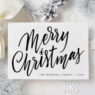Tarjeta de navidad de navidad con la mano de la mo