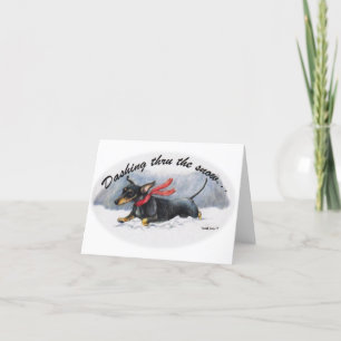 Tarjeta de Navidad del Dachshund corriendo por la 