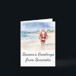 Tarjeta de Navidades Beach Santa Watercolor<br><div class="desc">Esta tarjeta de Navidad muestra a un Santa Claus relajado disfrutando de un largo paseo por la playa. Personalizar esta tarjeta de Navidades para reflejar tu ciudad de playa favorita!</div>