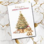 Tarjeta de Navidades de acopio Gold Tree Golden Re<br><div class="desc">En la parte delantera de esta tarjeta de Navidades, un adorable cachorro Golden Retriever lleva un sombrero de Santa Claus rojo y blanco y se sienta frente a un árbol de vacaciones. El árbol está decorado en oro, y debajo hay paquetes de regalos a juego. El texto dorado y rojo...</div>