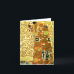 Tarjeta de nota de cumplimiento Gustav Klimt<br><div class="desc">Tarjeta de nota Gustav Klimt Fulfillment. Friso de 1909. Completada durante la fase dorada de Klimt, el Fulfillment presenta una pareja abrazadora que se sostiene bajo un tejido con múltiples patrones, con espirales, ojos, aves, peces y otras formas. El fondo de la obra incluye las mismas espirales de bronce que...</div>