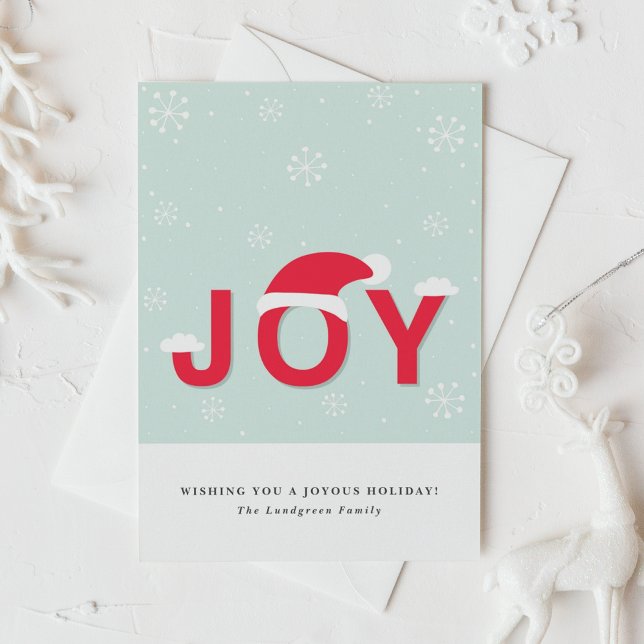 Tarjeta de saludo de vacaciones de la alegría de l (This holiday card design showcases the word “JOY” in lettering, playfully topped with a Santa hat.)