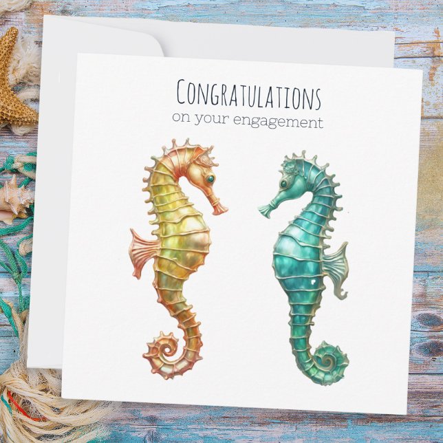 Tarjeta Elegantes caballitos de mar de Bonito compromiso d (An engagement card with a picture of two sea horses, one yellow and one turquoise)