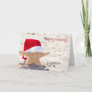 Tarjeta estrella de mar de Navidad en arena de playa