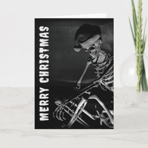 Tarjeta Feliz Navidad. Esqueleto con sombrero de Santa