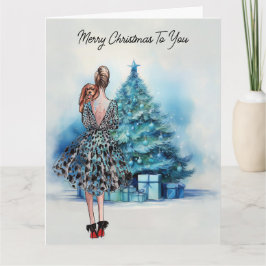 Tarjeta Feliz Navidad mujer y árbol azul de Navidad