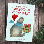 Tarjeta Festiva Beary Merry Christmas Cuear Santa Hat<br><div class="desc">La dulce y divertida tarjeta de vacaciones temática de un amigo forestal cuenta con un fondo de agua azul hielo con un oso envuelto en una bufanda y un sombrero Santa que se prepara para abrir un regalo de Navidad. El lado inverso es azul inverso medianoche con patrón de copos...</div>