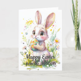 Tarjeta Festiva Conejo lindo sosteniendo huevo de Pascua y flores