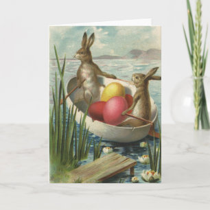 Tarjeta Festiva Conejos de Pascua antiguos en un barco con huevos