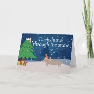 Tarjeta Festiva Dachshund a través de la nieve