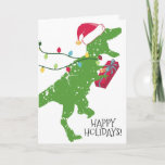 Tarjeta Festiva Derpy t-rex dinosaurios Navidades enciende Santa h<br><div class="desc">Dinosaurio T-Rex feliz y desdeñoso,  o tiránico rex con sombrero de Santa con campana y enorme sonrisa,  corriendo con un regalo de 4 años y luces de Navidad en esta tarjeta de vacaciones para niños de todas las edades.</div>