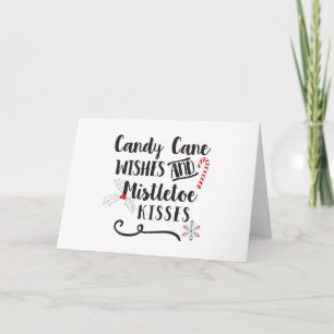 Tarjeta Festiva deseos de bastón de caramelo y besos bajo el muérd