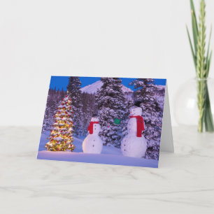 Tarjeta Festiva Dos hombres de nieve intercambian regalos por el 