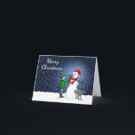 Tarjeta Festiva Edificio Snowman<br><div class="desc">El niño ha construido un muñeco de nieve en el que su perro se para y orina mientras el niño le da al hombre de nieve una nariz de zanahoria.</div>