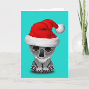 Tarjeta Festiva El bebé Koala usando un sombrero de Santa