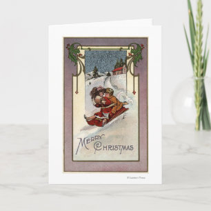 Tarjeta Festiva El feliz Sledding de ChristmasCouple