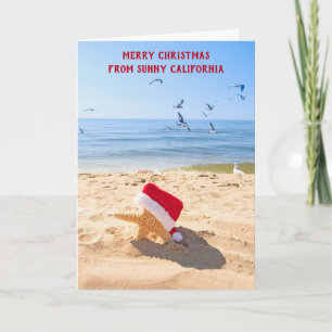 Tarjeta Festiva Estrella de mar Santa Claus en la arena