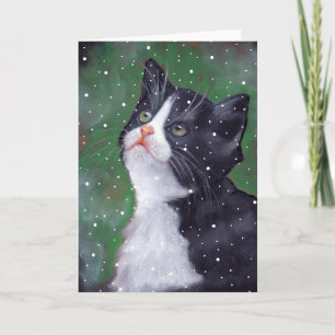 Tarjeta Festiva Gato esmoquin mirando hacia arriba a copos de niev
