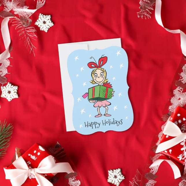 Tarjeta Festiva Grinch | Cindy-Lou Quién - Sosteniendo Regalo (Card on table)