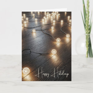 Tarjeta Festiva Luces de vacaciones en un suelo de madera