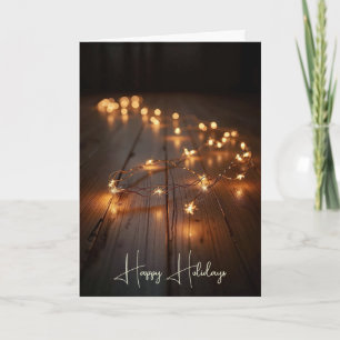 Tarjeta Festiva Luces Navideñas Brillando en un Suelo de Madera
