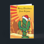 Tarjeta Festiva Navidades de Arizona Saguaro Cactus<br><div class="desc">Pequeño cactus de Saguaro en el desierto vistiendo un gorra Navidad y luces Navidades</div>
