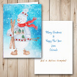 Tarjeta Festiva Navidades de esquí de Snowman<br><div class="desc">La parte delantera de esta tarjeta de Navidades tiene una acuarela de un lindo muñeco de nieve vestido con suéter invernal, gorra y bufanda. Está sosteniendo sus esquís y sus postes de esquí, y se coloca sobre una brillante nieve abstracta azul y fondo estrella. Dentro de la tarjeta hay campos...</div>