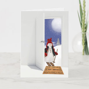 Tarjeta Festiva Navidades de snowman en esquís en la puerta