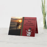 Tarjeta Festiva Navidades de Snowman, estudio de danza de Silhouet<br><div class="desc">Tarjeta de Navidades de estudio de danza o yoga. Perfecto para enviar a sus alumnos durante el descanso de sus Navidades. En la parte delantera hay una foto de una bailarina en silueta al atardecer en la playa. Un lindo muñeco de nieve está al lado en un fondo rojo navideño....</div>