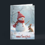 Tarjeta Festiva Navidades Snowman con conejito<br><div class="desc">Un muñeco de nieve con un gorra rojo y una bufanda se levanta alegremente al lado de un pequeño conejito,  también vestido cálidamente,  rodeado por un paisaje nevado con suave nevada. Se puede cambiar el texto.</div>