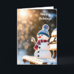 Tarjeta Festiva Navidades Snowman en un banco de parque<br><div class="desc">Navidades cortos snowman en un banco de un parque en un bosque invernal con vigas de sol</div>