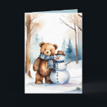 Tarjeta Festiva Navidades Teddy Bear Y Snowman<br><div class="desc">Oso de peluche marrón color agua en bosques de invierno con muñeco de nieve. El texto es editable.</div>