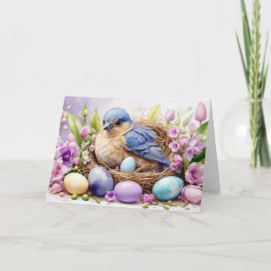Tarjeta Festiva Nido de pájaros azules y huevos de Pascua, flores 