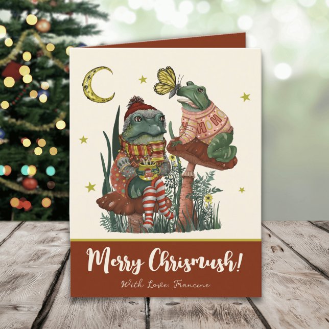 Tarjeta Festiva Nochebuena de hongos rojos y hongos (Whimsical Merry Christmas card with an illustration of frogs sitting on mushrooms drinking cocoa)