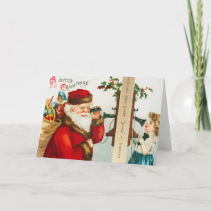 Tarjeta Festiva Papá Noel en los teléfonos de cuerdas escuchando a