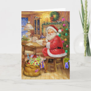 Tarjeta Festiva Papá Noel que trabaja en su escritorio