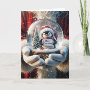Tarjeta Festiva Papá Noel sosteniendo un orbe de nieve de pingüino