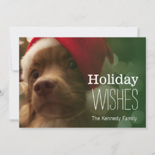 Tarjeta Festiva perrito que se sienta delante de bokeh del árbol