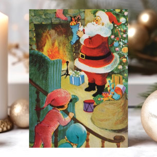 Tarjeta Festiva Santa Claus Vintage junto a la chimenea con niños