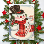 Tarjeta Festiva Snowman retro vintage en los mejores Navidades del<br><div class="desc">Personalizar esta linda tarjeta de Navidad vintage que muestra a un muñeco de nieve usando una bufanda roja y sombrero de top negro mientras sostiene un sorbo de mistletoe en una mano un bastón de caramelo en la otra. Personalice el texto agregando su nombre o utilice la herramienta de edición...</div>